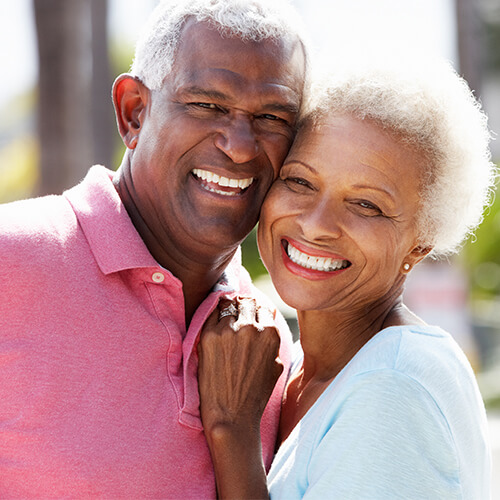 An elderly couple smiling together