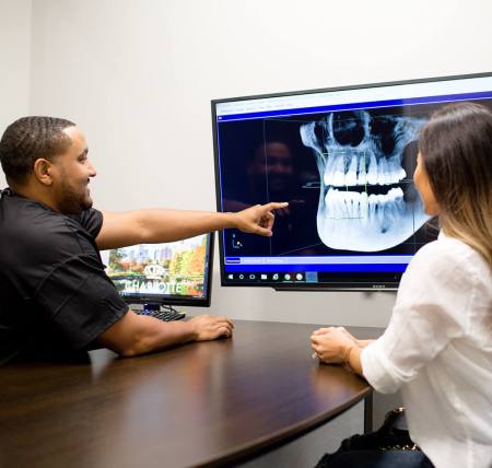 A North Carolina dentist at Night & Day Dental showing an X-Ray to a patient